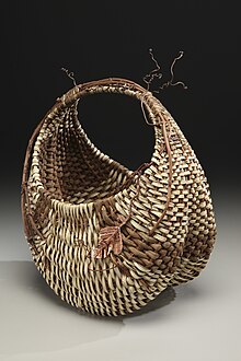 A basket with a large vine and its tendrils incorporated into the weave