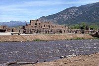 Taos Pueblo, a UNESCO World Heritage Site, is an Ancient Pueblo belonging to a Native American tribe of Pueblo people, marking the cultural development in the region during the Pre-Columbian era.