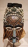 Ngaad-A-Mwash mask; by artists of the Kuba people; late 19th-early 20th centuries; wood, shells, glass beads, raffia and pigment; height: 82 cm; Detroit Institute of Arts, Detroit, Michigan, US[99]
