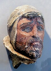 Painted sculpture of a young, bearded man