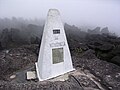 Border stone on the tripoint of Venezuela (foreground), Brazil, and Guyana located on Mount Roraima
