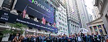 Image of people celebrating with confetti outside the New York Stock Exchange with a Dynatrace corporate banner that states 'Because the world needs software to work perfectly.'