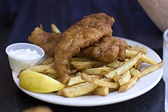 Fish and chips is an English dish of fried fish in crispy batter served with chips.