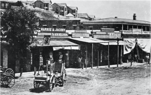 View to the NW of Old Downey Block, c.1870, before Downey Block was built in 1871: "Harris & Jacoby", forerunners to Harris & Frank and Jacoby Bros., and M. Kremer, forerunner of the City of Paris, the city's first department store