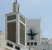 Minaret of Zawya Moulay Abdelkader adjacent to the Phoenix building near the Royal Palace