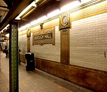 Mosaic name tablet and cartouches on the Eastern Parkway Line platform