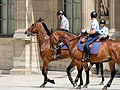 Mounted guards in service dress patrolling near the Louvre