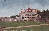 A croquet lawn with a hotel in the background