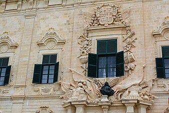 Part of the façade of Auberge de Castille (1741–45), showing Pinto's bust and coat of arms