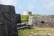 The evolution of coastal fortification design, between the 1790s and 1822, can be discerned between Ferry Island Fort (in the foreground), with multiple guns arrayed to cover the water westward, and the Martello tower in the background, which used a single gun with 360° traverse to cover the area.