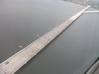Arial view of the bridge with its alternating American and Puerto Rican flags