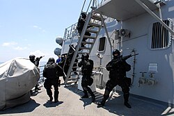 Members of the Brunei Special Forces rush towards the pilot house of USS Howard (DDG-83) during a visit, board, search and seizure exercise, August 2008.