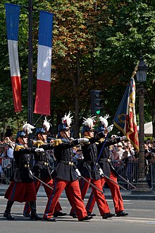 Example of dual degree with the Grande Ecole and French foremost military academy Saint Cyr, as part of which INSEEC students can complete the last year of their Grande Ecole master's degree curriculum, at the end of which students will earn their stripes as reserve officer, and if they wish so, can start missions as sub-officers (in French: sous-officiers). On this picture, the Colour Guard marching on the Champs-Elysées Avenue in Paris on Bastille Day.
