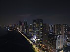 Aerial view of Gurney Drive, lined with skyscrapers, at night