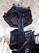 The wooden pulpit with its huge tester