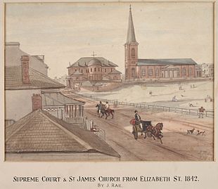 Watercolour of St James' next to the Supreme court. The view is looking north along an unpaved road (now Elizabeth Street) on which there are people walking, riding horses and driving carriages. An empty space (now Hyde Park) appears on the right hand side.