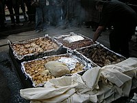 A Hāngī being prepared, a New Zealand Māori method of cooking food for special occasions using hot rocks buried in a pit oven.