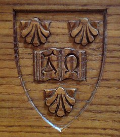 The college's arms on oak wood