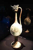 A monumental ewer with incised floral lozenges and clouds, made of glazed stoneware with copper-green splashes over a white slip; probably from the Gongxian kilns, Henan