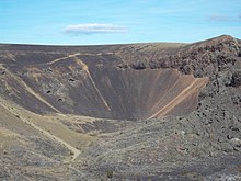 A deep crater with brown coloured rocks