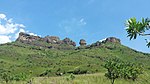 Rock formations on the top of a hill, lush green vegetation