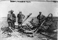 Four men with wreckage of Blériot's plane at Reims, 1909
