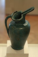 Etruscan flagon; note the two reclining animals on the rim.