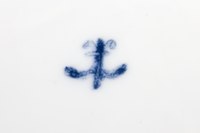 The early form of the factory mark, a fleur-de-lys (upside down, from the writing-set).