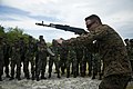 U.S. Marine teaching a reloading technique with the AK-103 to Maldives National Defense Force members