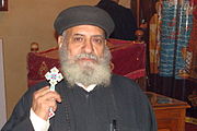 Coptic priest holding a hand-held blessing cross (Cairo, 2010)