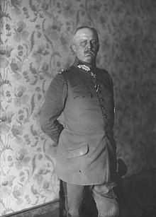 Black and white photo of an elderly man standing in military garb