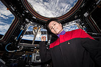 Cristoforetti in Star Trek uniform in the ISS Cupola with a view of SpaceX CRS-6