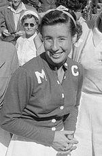 A woman looking and smiling toward the camera