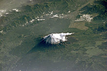 Mount Fuji as seen from space, with surrounding forest