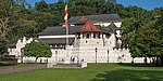 A Buddhist temple in white stone and a flag in front