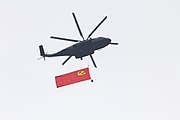 Z-8L carrying the flag of the Chinese Communist Party flying over Beijing on 1 July 2021.