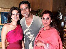Kapadia and her daughter and son-in-law looking at the camera