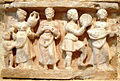 Hellenistic banquet scene from the 1st century AD, Hadda, Gandhara. Short-necked, 2-string lute held by player, far right.
