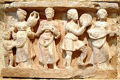 Art from Gandhara in the 1st century AD showing a banquet and lute player