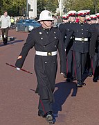 Royal Marines other ranks wearing Number 1A uniform with peaked caps (right), and in greatcoat order with pith helmet (left).