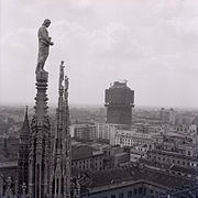 The tower during construction, seen from the Duomo of Milan