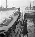 Wrens of the British Fleet Mail load the packet boat to deliver letters and parcels to the men on board ships moored nearby