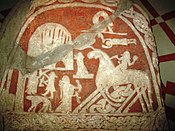 A female figure bears a horn to a rider on an eight-legged horse on the Tjängvide image stone in Sweden.