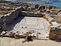 The ruins of a home with a mosaic floor