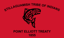 Flag of the Stillaguamish Tribe of Indians. The flag is a red banner with a salmon drawn in the traditional Coast Salish art style. Above the salmon is written "Stillaguamish Tribe of Indians." Below the salmon is written "Point Elliott Treaty 1855"