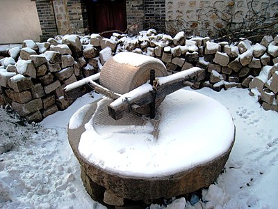 Grain millstone in the snow in northern China.
