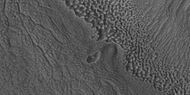 Close view of contact, as seen by HiRISE under HiWish program Picture shows details of how upper plains material is breaking. The formation of many fractures seems to proceed the break up.