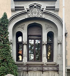 Romanian Revival cartouche above a window of the Aurel Mincu House (Bulevardul Dacia no. 60), Bucharest, by Arghir Culina, 1910[19]