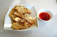 A plate of fried wontons called pangsit goreng (锦卤馄饨) with sweet and sour sauce, from Indonesian Chinese cuisine