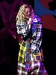 Rita Ora performing in Glasgow in 2018, wearing a tartan trench coat made of at least five different setts